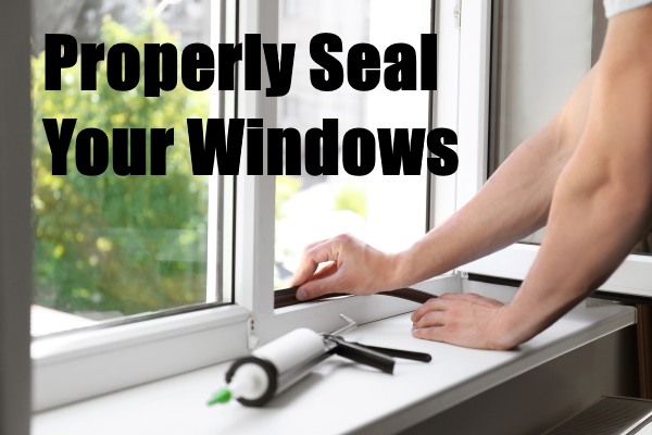 Construction Worker Sealing Window With Caulk Indoors